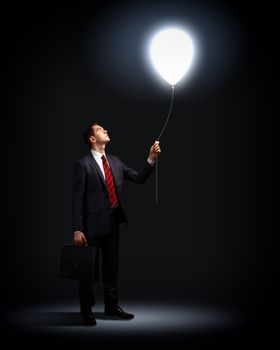 Light bulb and a business person as symbols of creativity in business