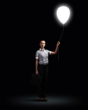 Light bulb and a business person as symbols of creativity in business