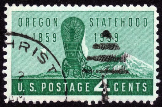 USA - CIRCA 1959: A Stamp printed in USA shows the covered Wagon and Mount Hood, Oregon Statehood , Centenary, circa 1959