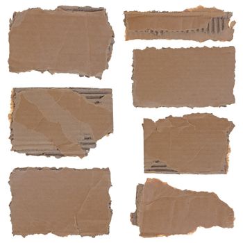 Collection of seven torn carboard pieces isolated over white background