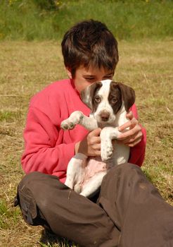 little girl and her puppy purebred pointer in a field