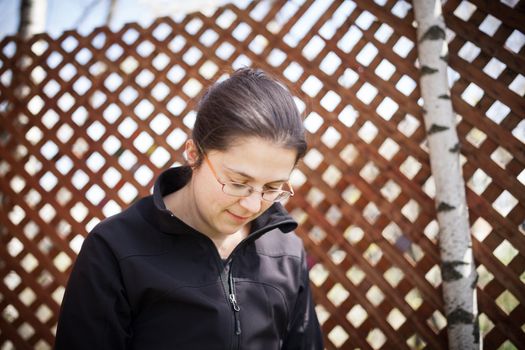 woman reading on her smart phone in a treehouse