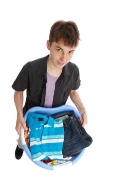 Teenage boy holding a basket of clothes.