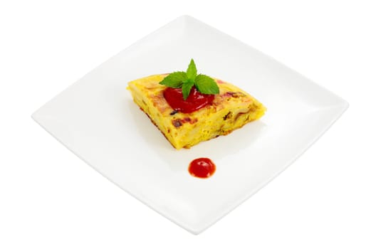 dish with portion of spanish omelet made with potato egg peppers and onion cut and isolated