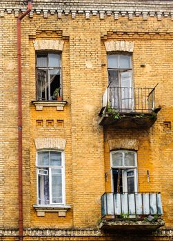 Old painted  brick wall with open windows, Kyiv, Ukraine