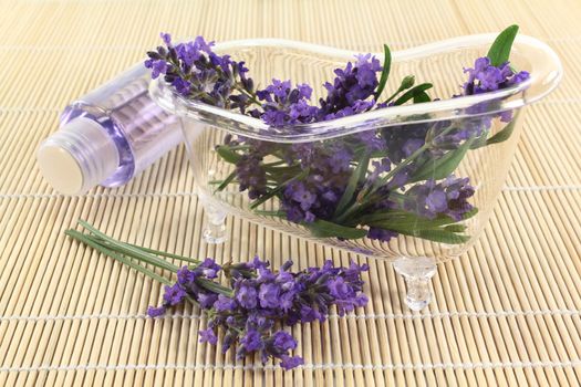 a bath tub with lavender flowers and lavender oil
