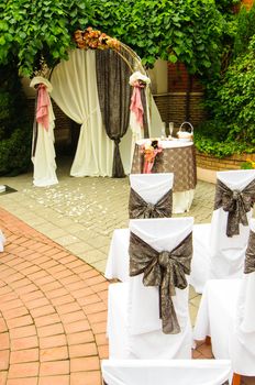 Outdoor wedding arch with table under grapevine