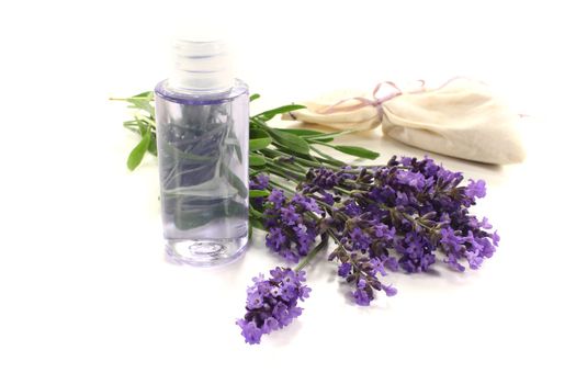 Lavender oil with Lavender bag and fresh flowers on a light background