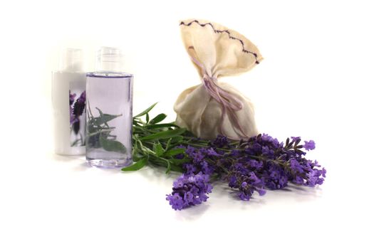 Lavender oil with Lavender bag and lilac flowers on a bright background
