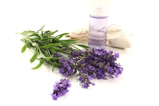 Lavender oil with Lavender bag and fresh lilac flowers on a bright background