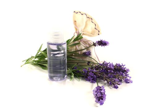 Lavender oil with Lavender bag and flowers on a bright background