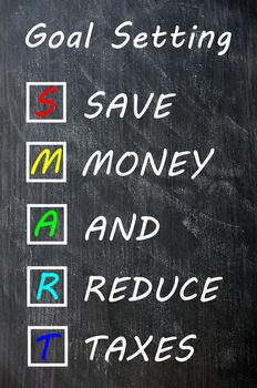 Smart goal setting concept on blackboard for save money and reduce taxes