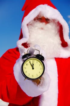 Santa Claus, Father Christmas holds watch clock
