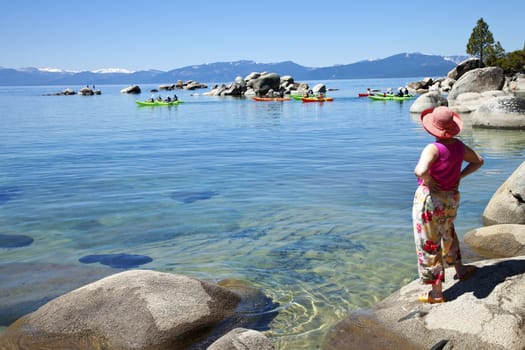 Team of kayaks paddling together in Lake Tahoe, CA.