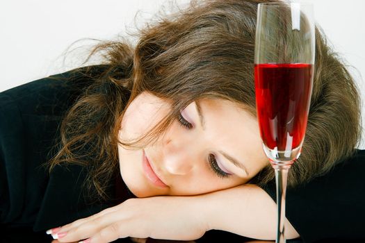 Sleeping girl and a glass of wine