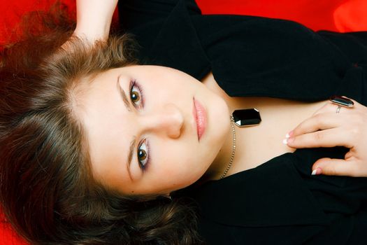 Attractive sexy brunette on a red blanket