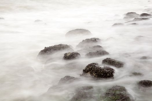 stones in sea waves at long exposure