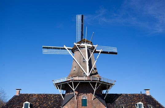 old windmill in Drenthe over clear blue sky