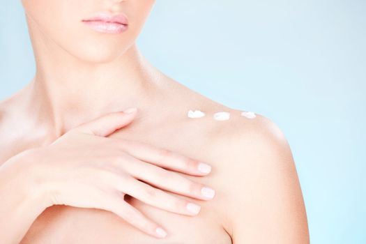 cosmetic cream on woman's shoulder