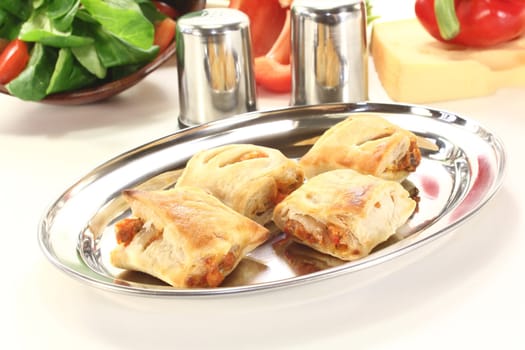 Puff pastry filled with cheese and bell peppers on a bright background