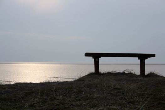 Empty bench up in the dunes of Mandoe island, Denmark. View to the North Sea.