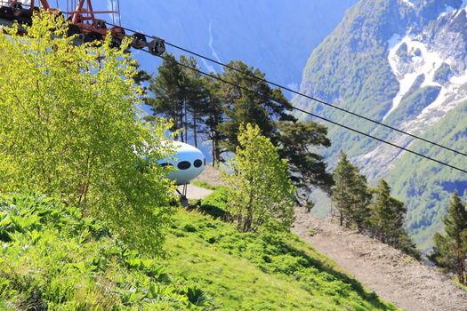 Image of landscape with Caucasus mountains and UFO