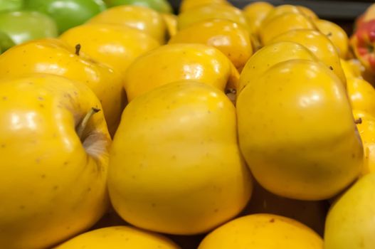 yellow apples on display at farmers market