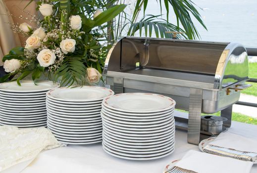 Italian Catering food warmer empty with white plate on a wedding celebration