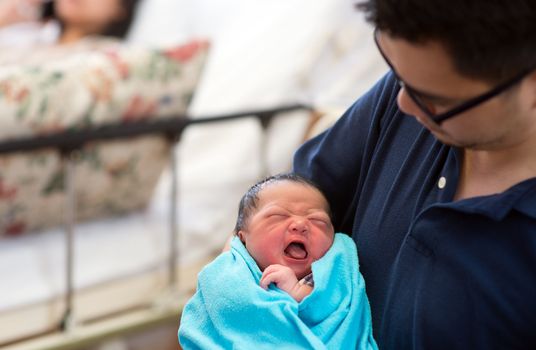 Asian newborn baby girl and daddy in hospital