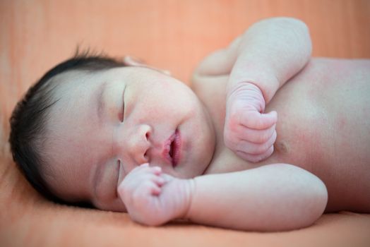 Newborn Asian baby girl sleeping, 7 days after birth