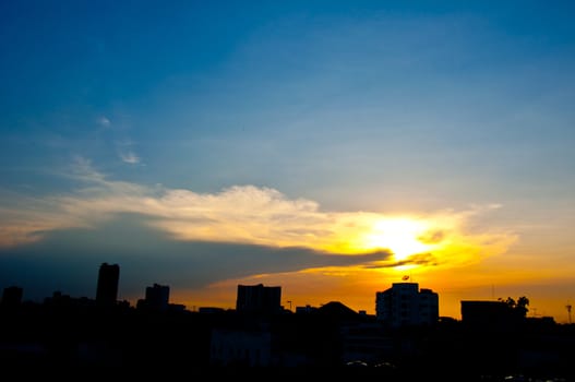 sundown with building in city