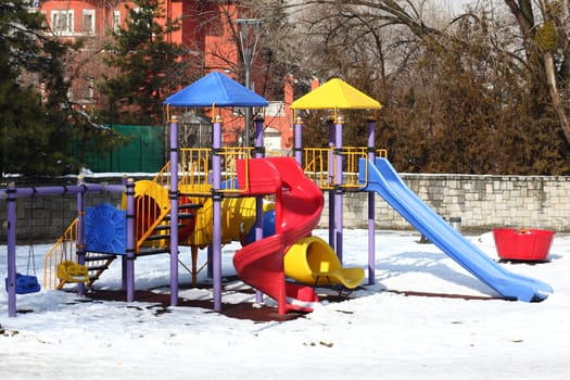 Colorful slides in the park under the snow