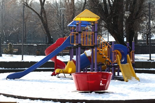 Colorful slides in the park under the snow