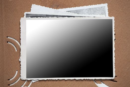 Blank photo frame on a stack of old photos. Clipping path included for eassy issolation