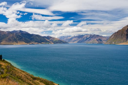 Vivid blue surface of big mountain Lake Hawea, Central Otago, New Zealand