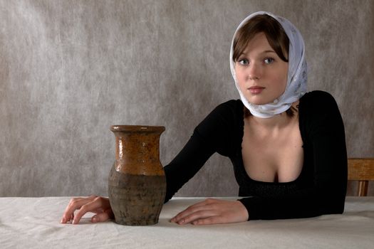 Portrait of the girl in a kerchief in an interior