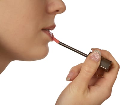 The girl painting lips on a white background