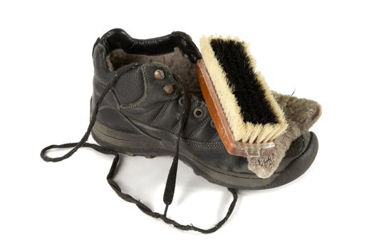 Old boot with  shoe brush on a white background