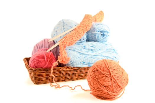 multicolored clews in   basket isolated on a white background
