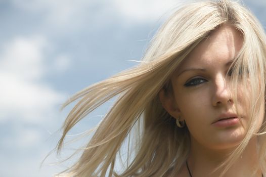  beautiful girl on a background of the blue sky