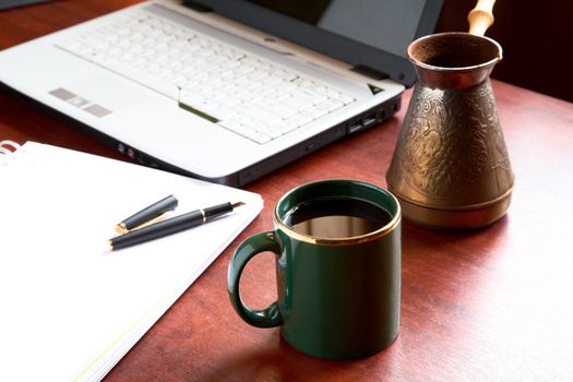 Cup of morning coffee on a table at office