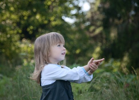  little girl on a background of green wood