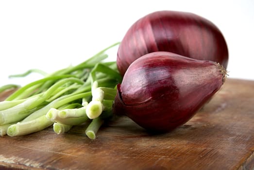 bulb and green onion a chopping board