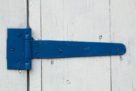 Blue door hinge, on a white painted doors