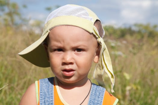 little boy on a meadow in the summer