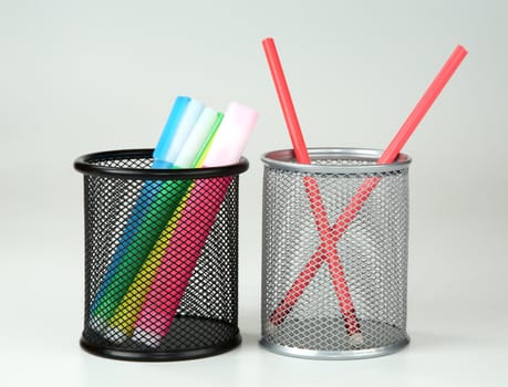 Markers and pencils in supports on a grey background