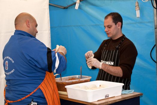 Buenos Aires, Argentina - May 12, 2012, Men preparing empanadas typical of Argentina at the fair organized nations in the city of San Fernando, Province of Buenos Aires