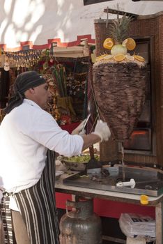 A man cooking shawarma in stand of Arabia in the fair of the nations in the locality of San Fernando province of Buenos Aires Saturday 12 of May of 2012.