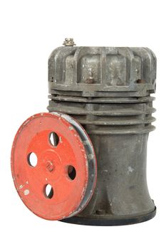 Old air compressor with pulley, isolated on white background
