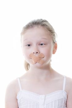 preteen girl with sticking plaster across her mouth